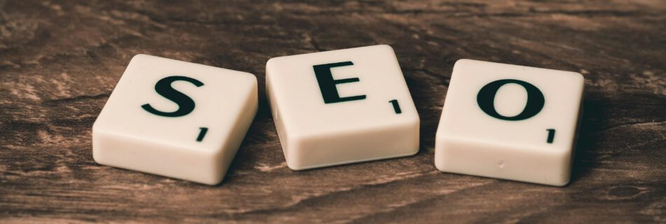 Three White-and-black Scrabble Tiles on Brown Wooden Surface